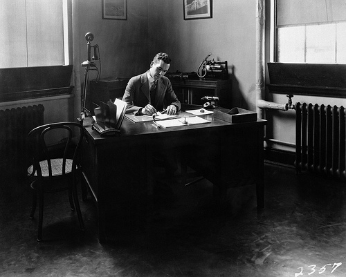 The youthful engineer-in-charge Henry J.E. Reid sits at his desk, April 1928. Rights: NASA on the Commons